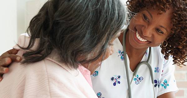 healthcare professional smiles at patient